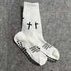 White athletic socks with black cross patterns and text printed on the foot.