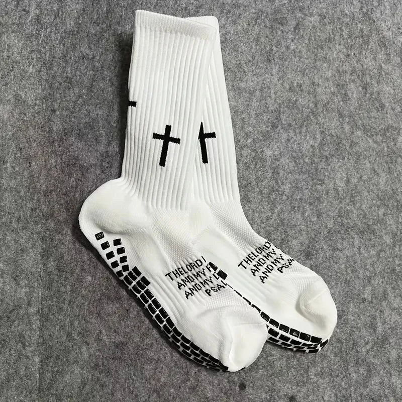 White athletic socks with black cross patterns and text printed on the foot.