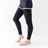 Black unisex compression thigh high socks worn by a person.