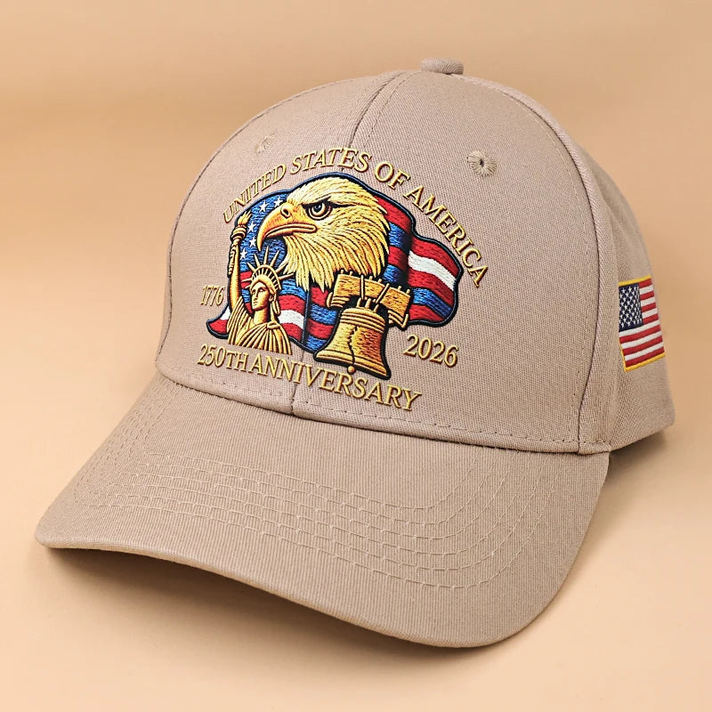 A beige cotton adjustable peak hat featuring a graphic of an American bald eagle and text celebrating the 25th anniversary.