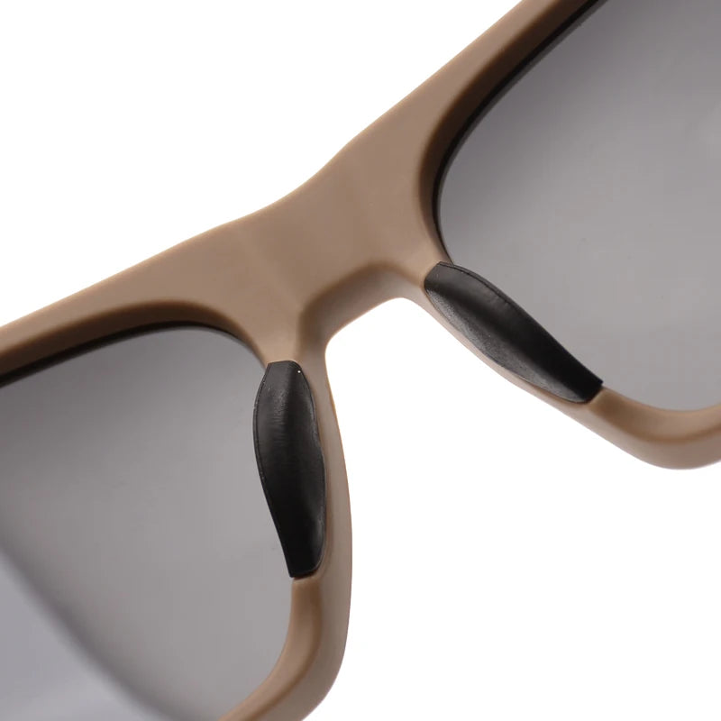 A close-up view of light beige polarized sports sunglasses with black accents.