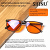 Orange lens blue light blocking glasses shown on a wooden surface