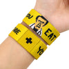 Yellow silicone wristband bracelet with black text and a plus sign on the back