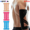 Five pieces of black kinesiology support tape applied to the back and shoulder area.