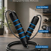 A black fitness helper jump rope with a durable steel wire rope and comfort grip is shown on a wooden surface.