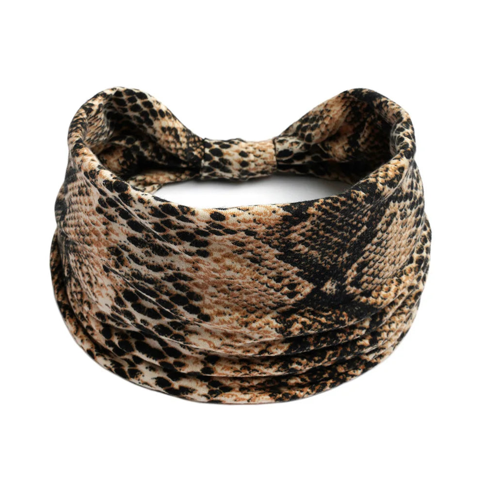 A close-up of a black and tan patterned fabric headband.