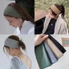 A collection of wide bohemian print headbands in various shades of green, beige, and black.