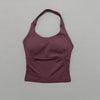 A solid plum-colored seamless performance yoga and gym tank top displayed against a light gray background.