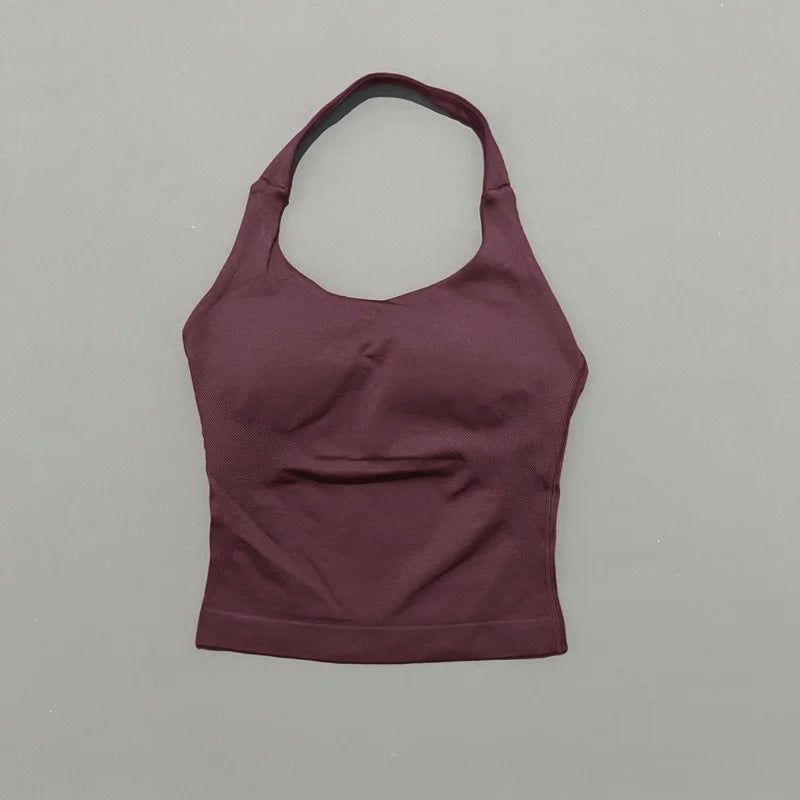 A solid plum-colored seamless performance yoga and gym tank top displayed against a light gray background.