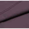 Close-up of a mauve women's high-waist flared yoga pant fabric with a stitched seam detail.