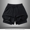 Black men's quick-dry athletic shorts laid flat on a gray background