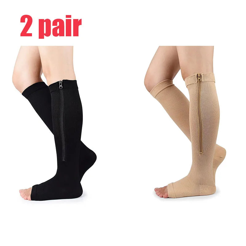 A pair of black and beige compression zippered stockings shown on legs.
