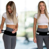 Two women wearing gray athletic wear and black pelvic support belts standing in a bright gym setting.