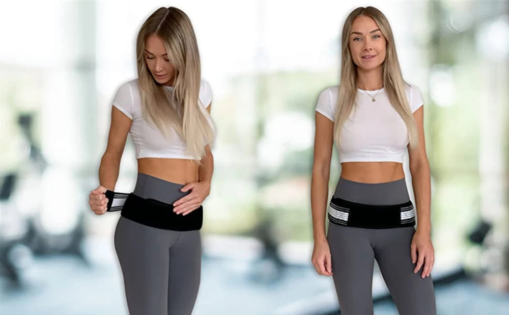 Two women wearing gray athletic wear and black pelvic support belts standing in a bright gym setting.