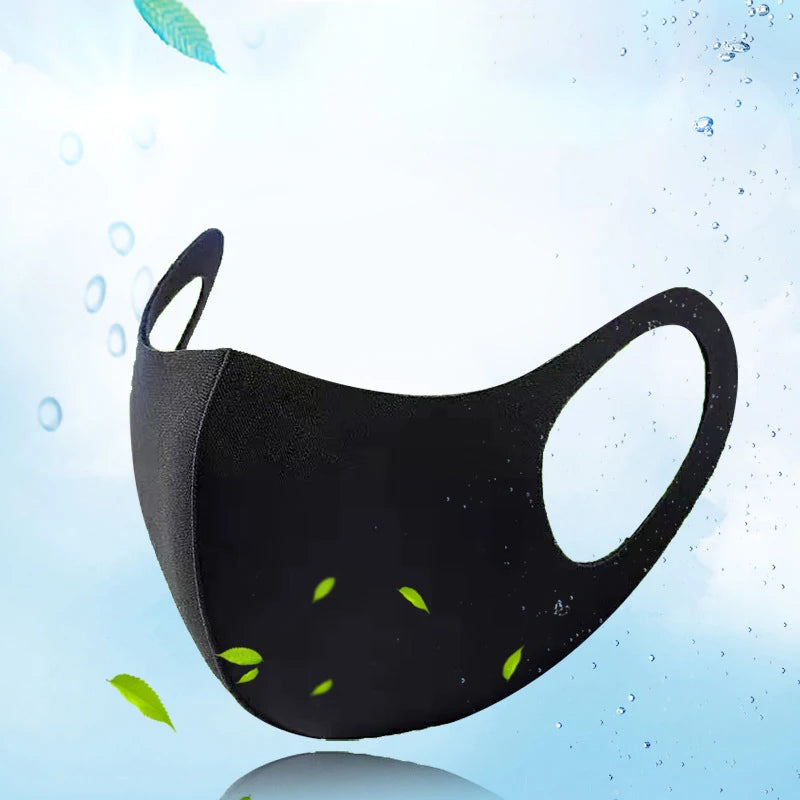 Black UV protection face mask with green leaves floating in clear water droplets.