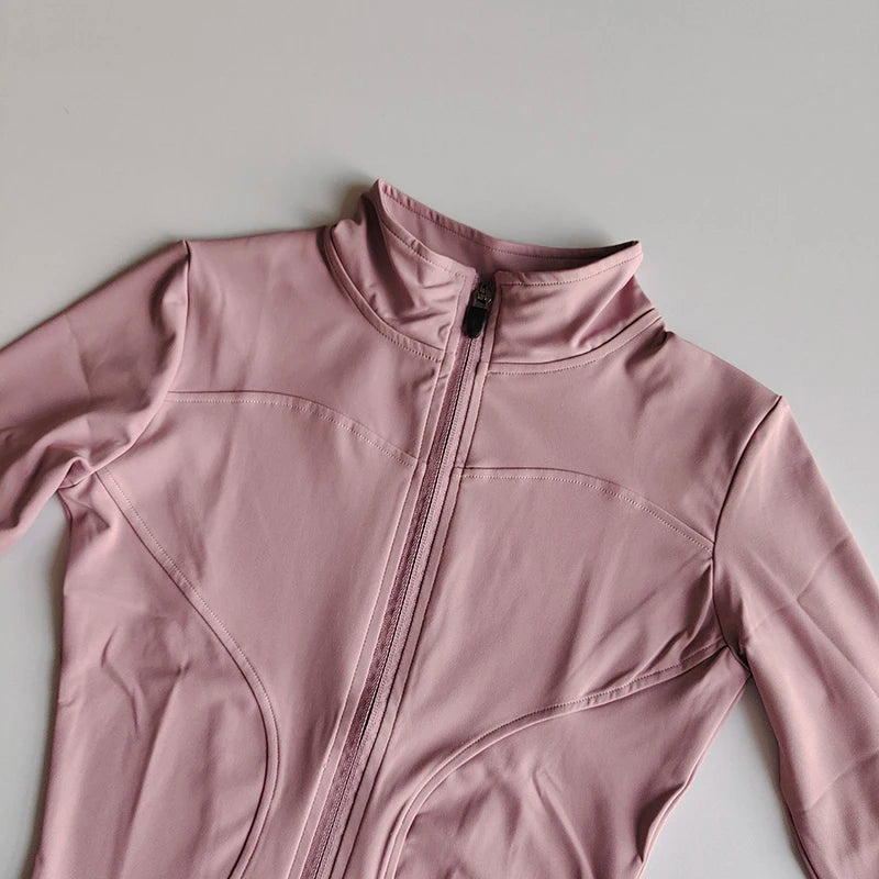 A light pink quick-dry yoga and fitness jacket with a full zip collar shown from the chest up.