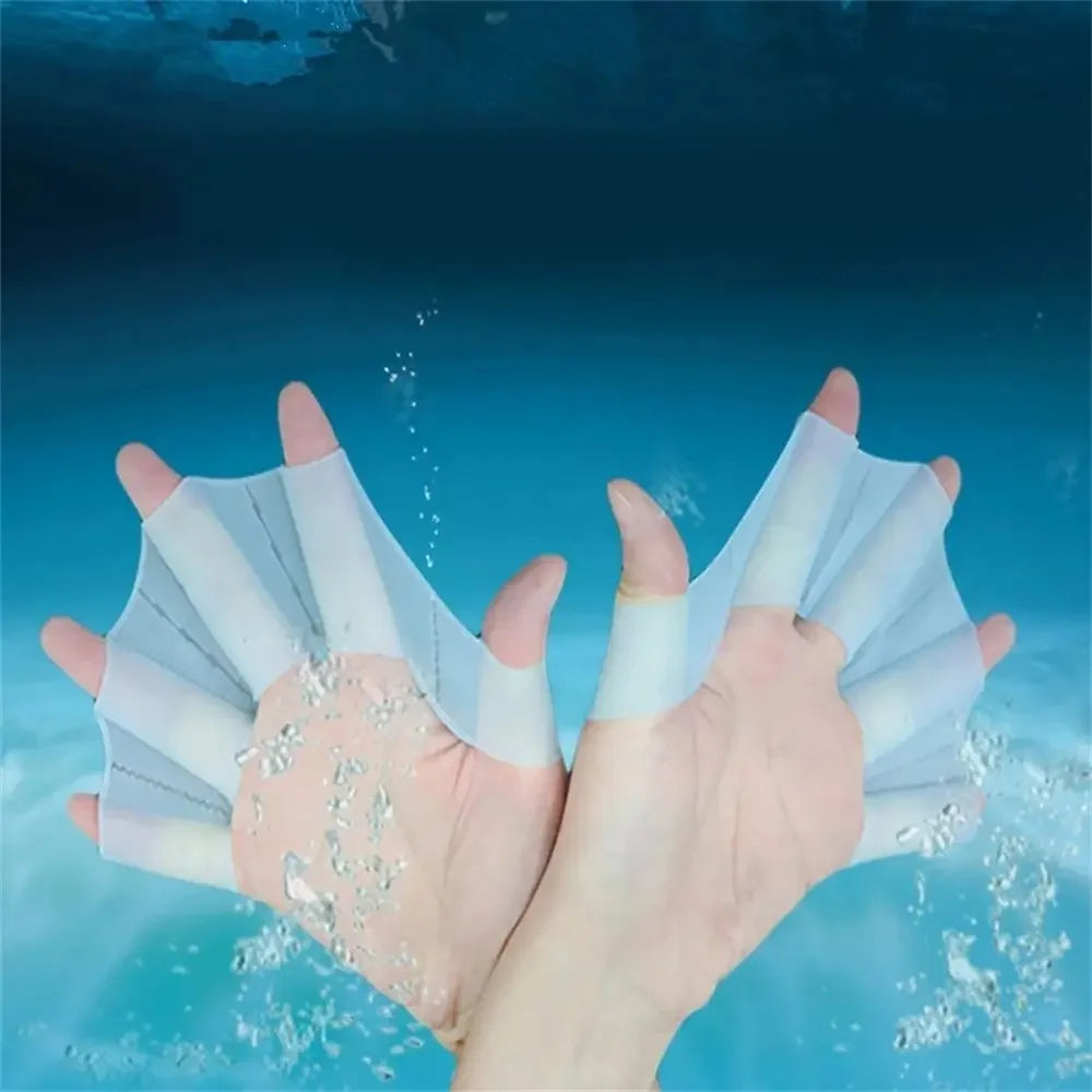 A hand is shown wearing silicone swim training flippers, with water droplets visible around the fingers.