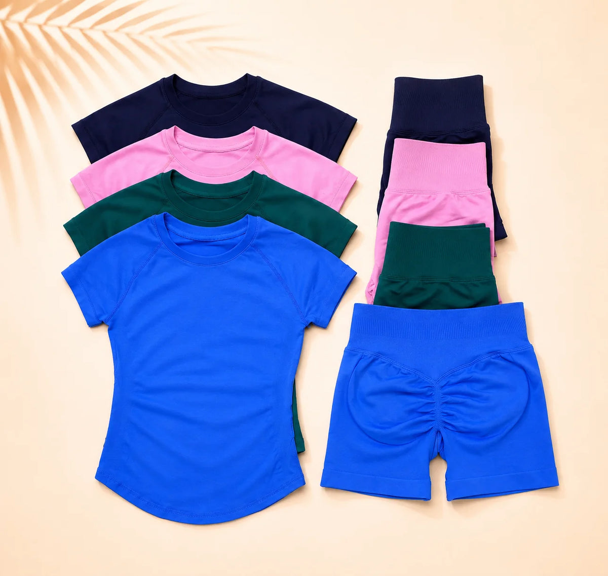 A stack of seamless high-waist yoga set tops and bottoms in various shades of pink, green, and blue.