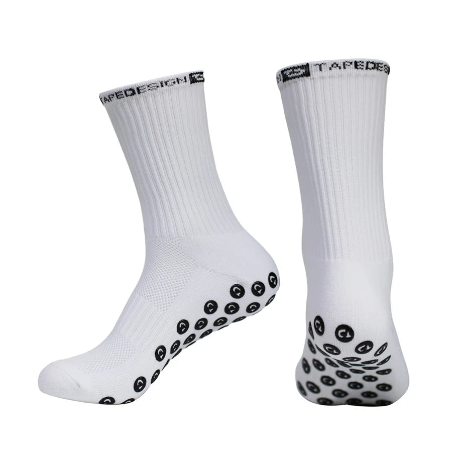 A pair of white performance sports gripping socks with black patterned grips.