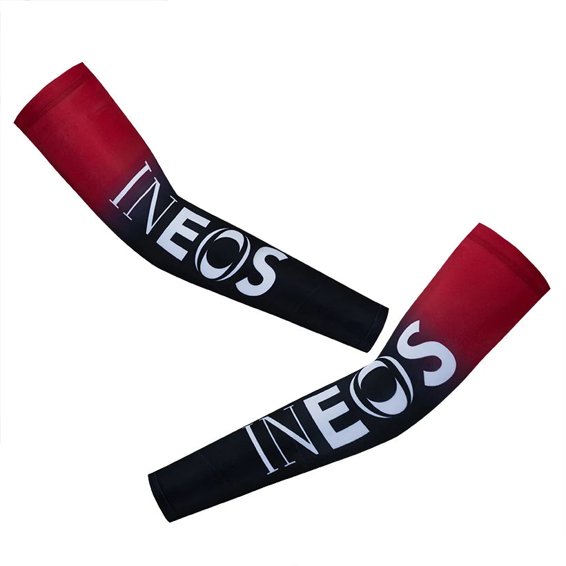 A pair of red and black cycling arm warmers with the brand name INEOS printed on them.