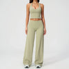 A woman wearing a light olive green women's premium fitness tracksuit top and matching pants.