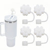 A set of silicone straw covers for tumblers and water bottles, including a lid and multiple flower-shaped covers.