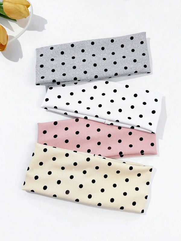 Un set de quatre élastiques pour cheveux à pois gris, blanc, rose et beige, présentés sur une surface blanche.