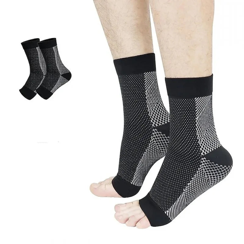 A pair of black and white patterned ankle compression socks shown on a foot.