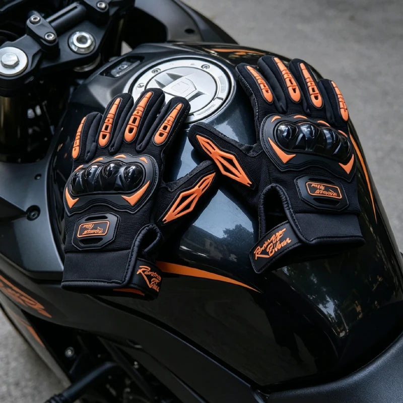 Close-up of black motorcycle riding gloves with orange accents on a black motorcycle helmet.