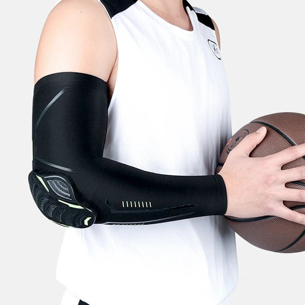 A person wearing black sports compression elbow and knee pads while holding a brown football.