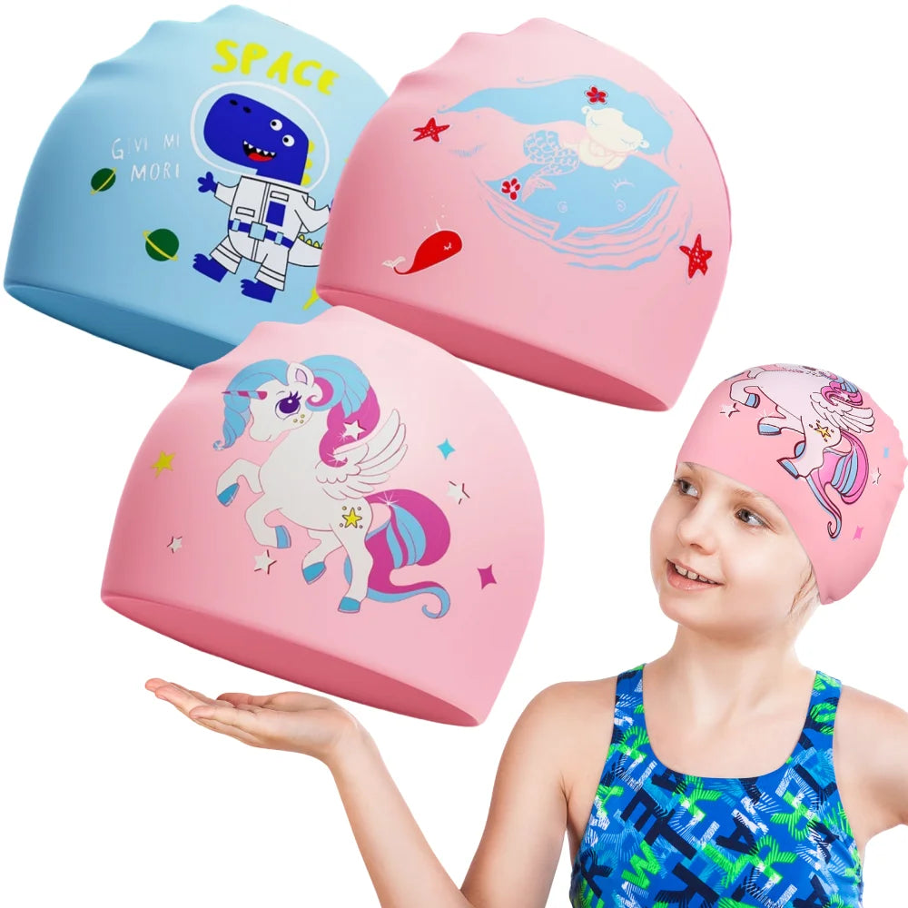 A young girl is holding a pink silicone swimming cap featuring a unicorn design and a blue cartoon character.