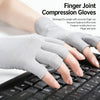 Gray finger joint compression gloves being worn on a hand resting above a black computer keyboard.