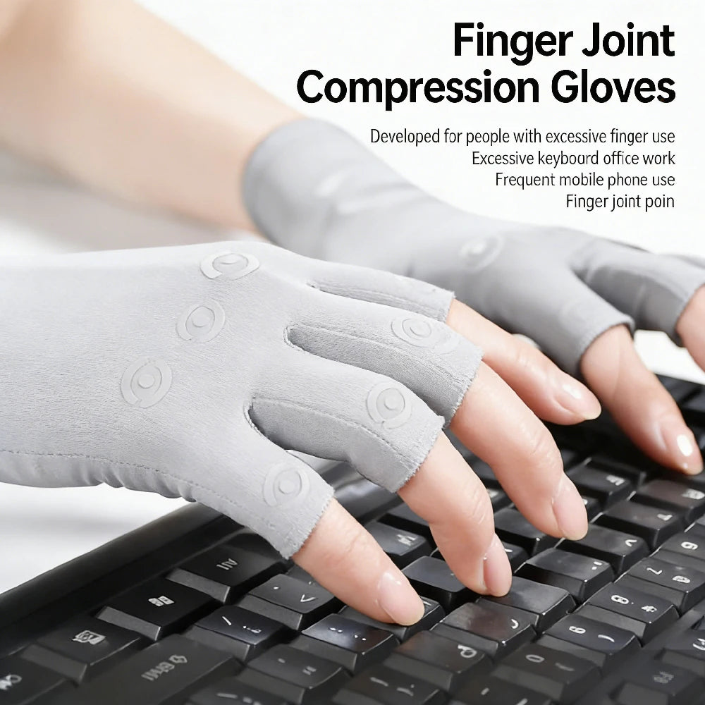 Gray finger joint compression gloves being worn on a hand resting above a black computer keyboard.