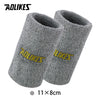 A pair of gray wool wristbands for sport or activewear