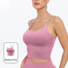 A model wearing a pink summer strappy yoga sports bra top and matching bottoms.