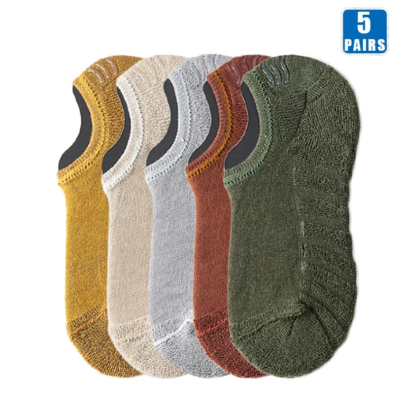 Five pairs of men's cotton crew socks in various earth tones including yellow, beige, gray, brown, and olive green.
