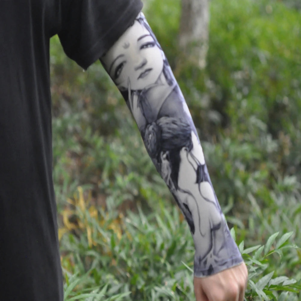 A person wearing a black garment is displaying an arm with a black and white ice silk tattoo sleeve.