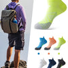 A variety of breathable anti-blister running socks in various colors and patterns displayed next to a person wearing athletic