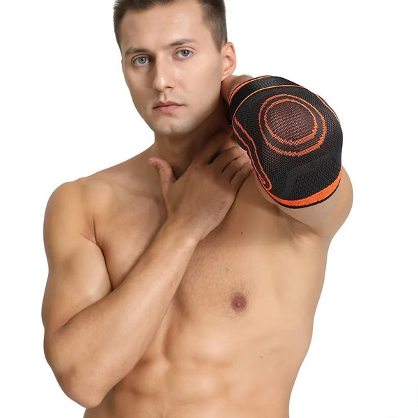A man wearing an orange and black joint support elbow protector sleeve on his arm.