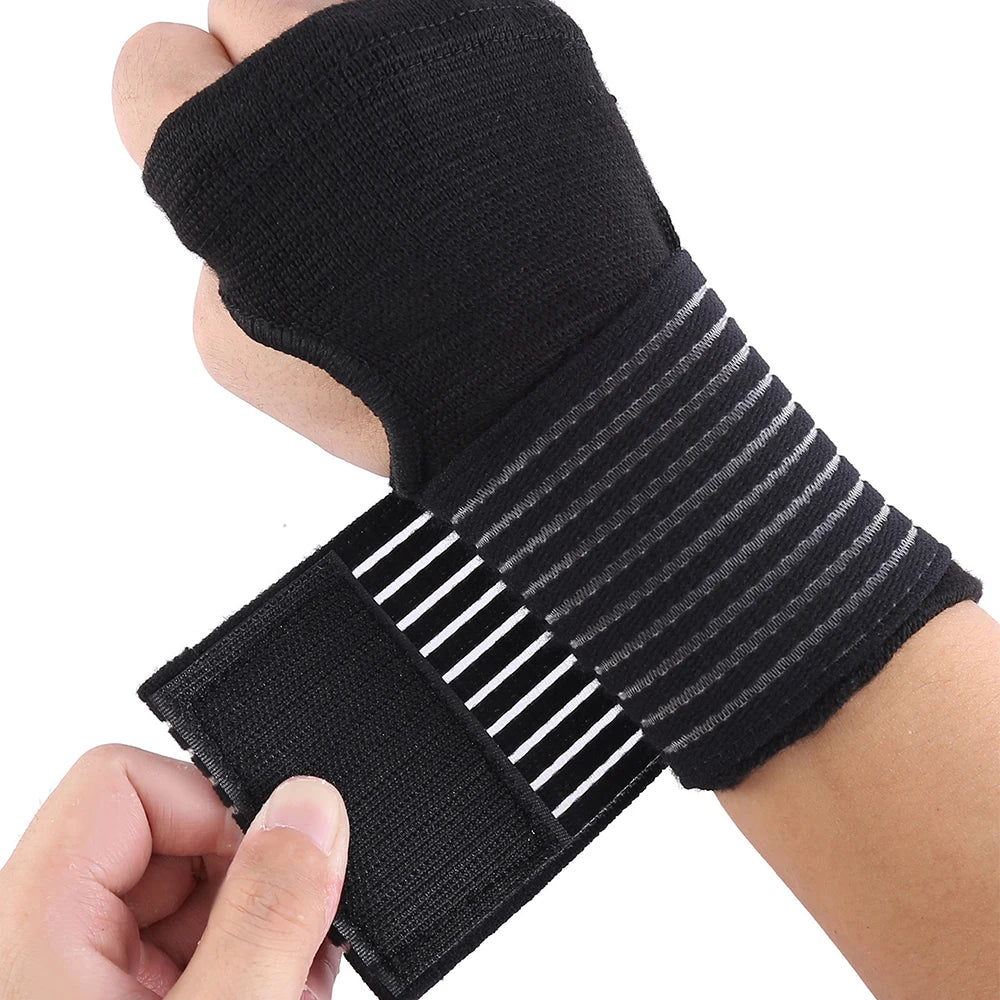 Black elastic wrist support brace with gray stripes and white lines being worn on a hand.
