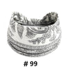 A close-up of a white cotton boho print headband folded and displayed.