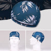 Casquette de bain en nylon élastique bleu foncé avec motif de feuille blanche sur un mannequin.