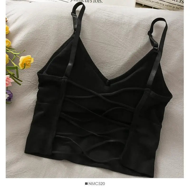 Black off-shoulder camisole tank top for women displayed on a light fabric.