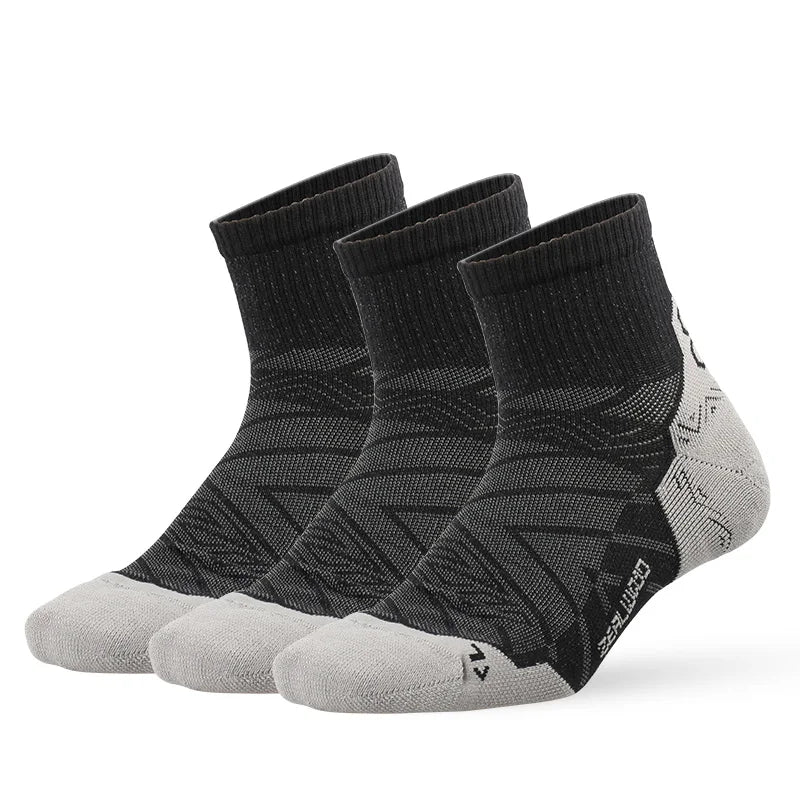 A set of three black and gray breathable performance running socks displayed flat.