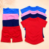 A colorful seamless high-waist yoga set for women featuring tops and shorts in blue, pink, purple, and red.
