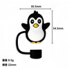 A black silicone straw cover shaped like a penguin with yellow accents.