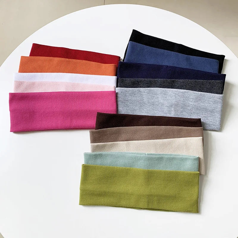 A pack of five colored elastic hairbands for fitness and yoga displayed on a white surface.