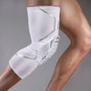A white compression knee brace with silver accents is worn on a person's leg.