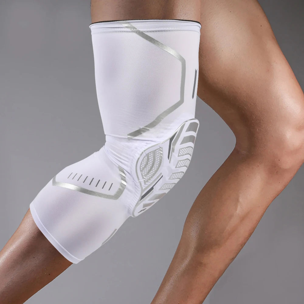 A white compression knee brace with silver accents is worn on a person's leg.