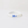 A white silicone wristband with the number 30 printed on it.
